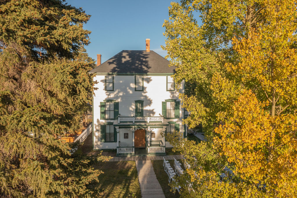 green house with trees on both sides of it.