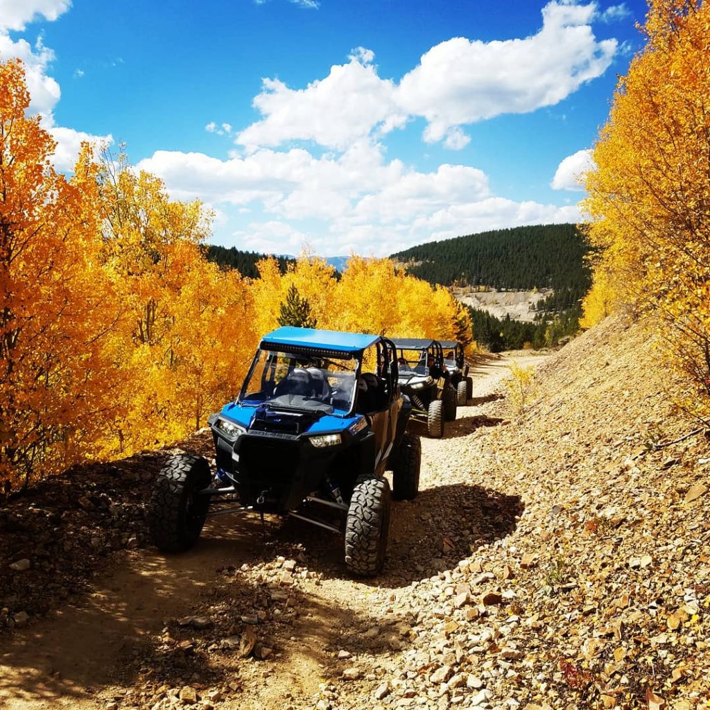 side by sides on a trail in fall.