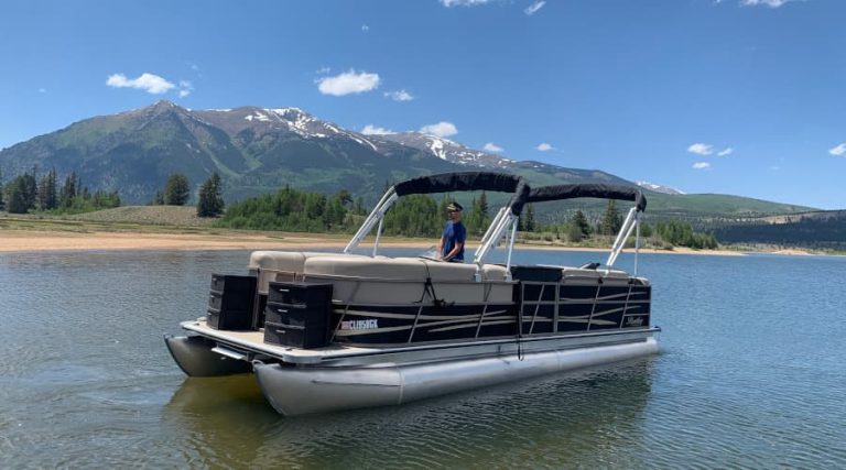 Pontoon boat on Twin Lakes with mountains in the background