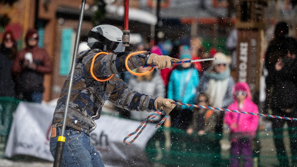 person taking rings off of a hanging poll.
