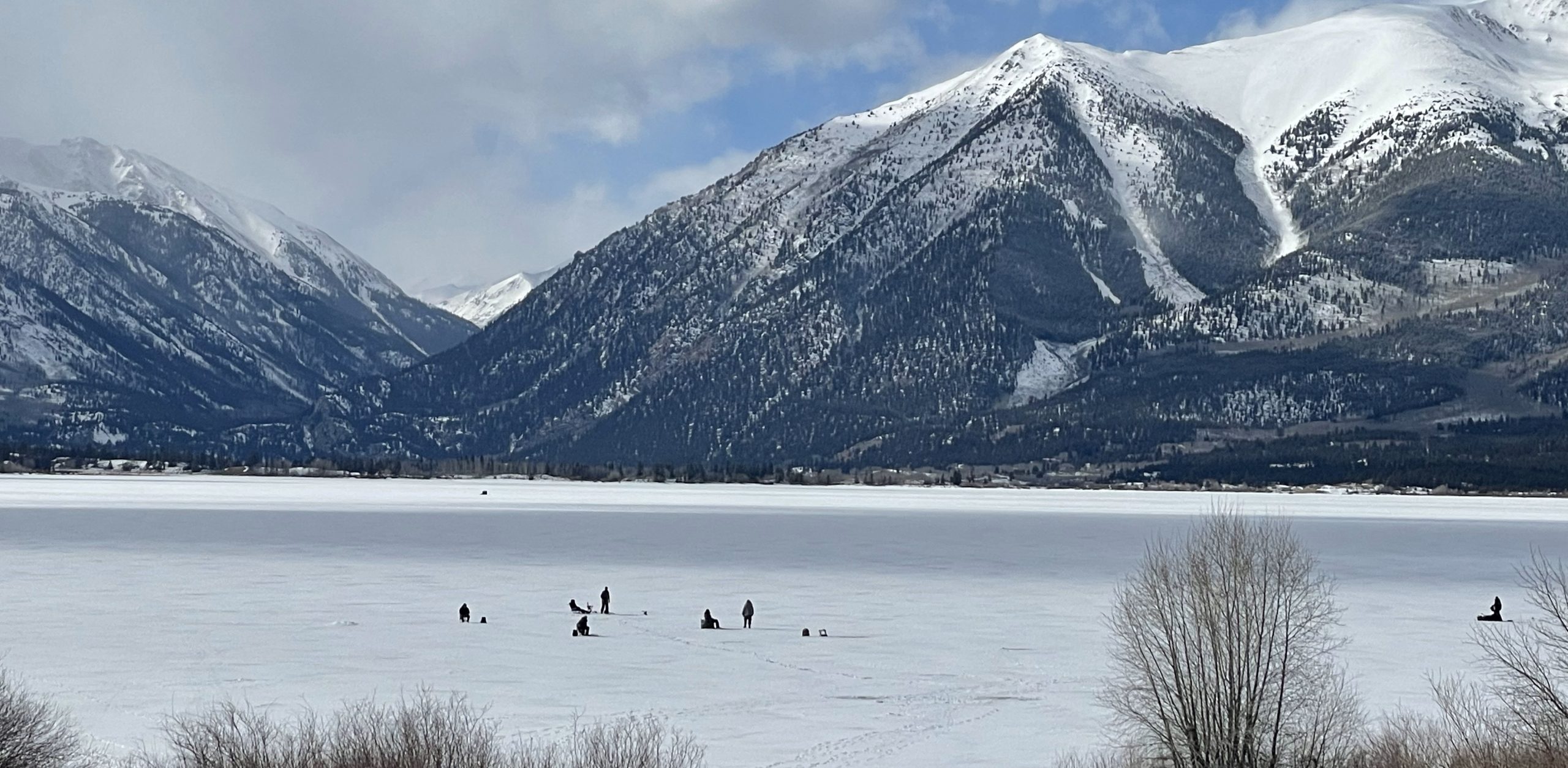 frozen lake with mountains in the background.