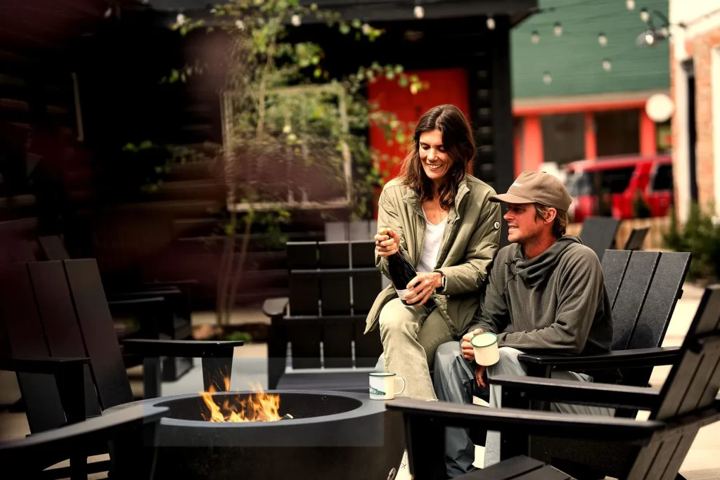 two people sitting by a fire.