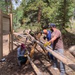 people working on a fence.