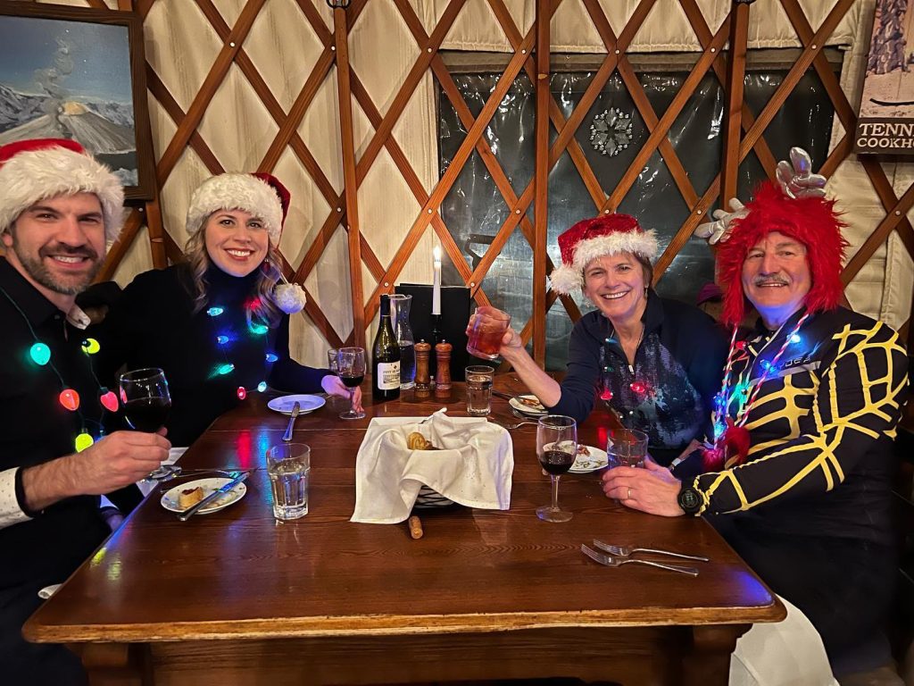 Friends celebrating the holidays together inside the Tennessee Pass Cookhouse yurt