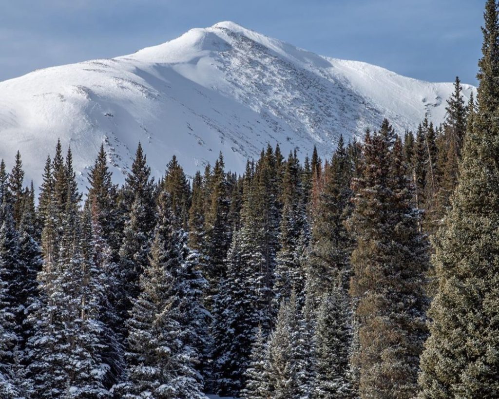 A family cross country skiing together on groomed trails near Leadville, Colorado
