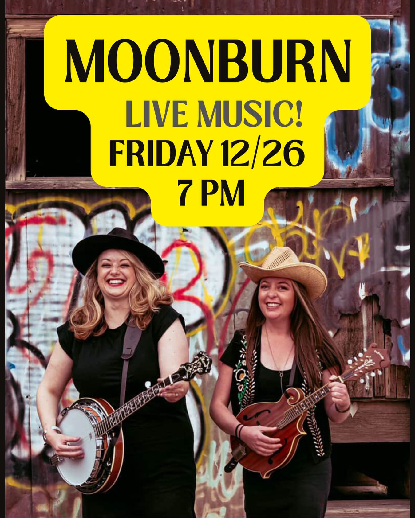Two smiling women with banjo and mandolin against a graffiti backdrop. Text above announces "Moonburn Live Music! Friday 12/26, 7 PM."