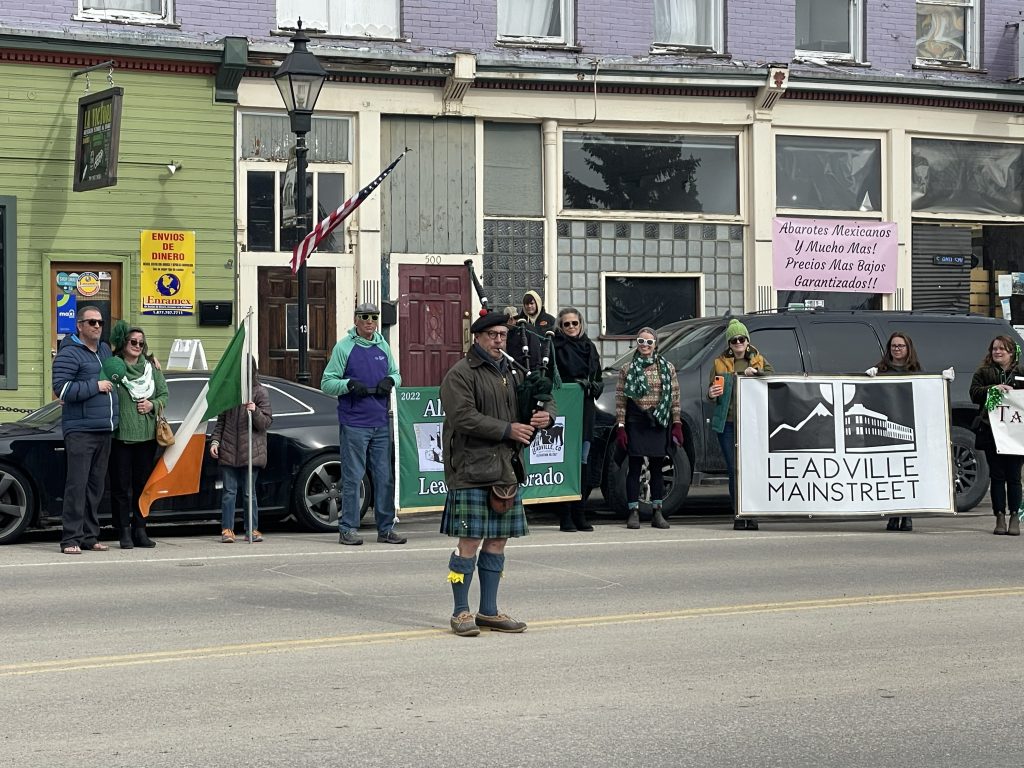 A bagpiper leads the St. Patrick’s Day practice parade past storefronts on Harrison Avenue in Leadville.