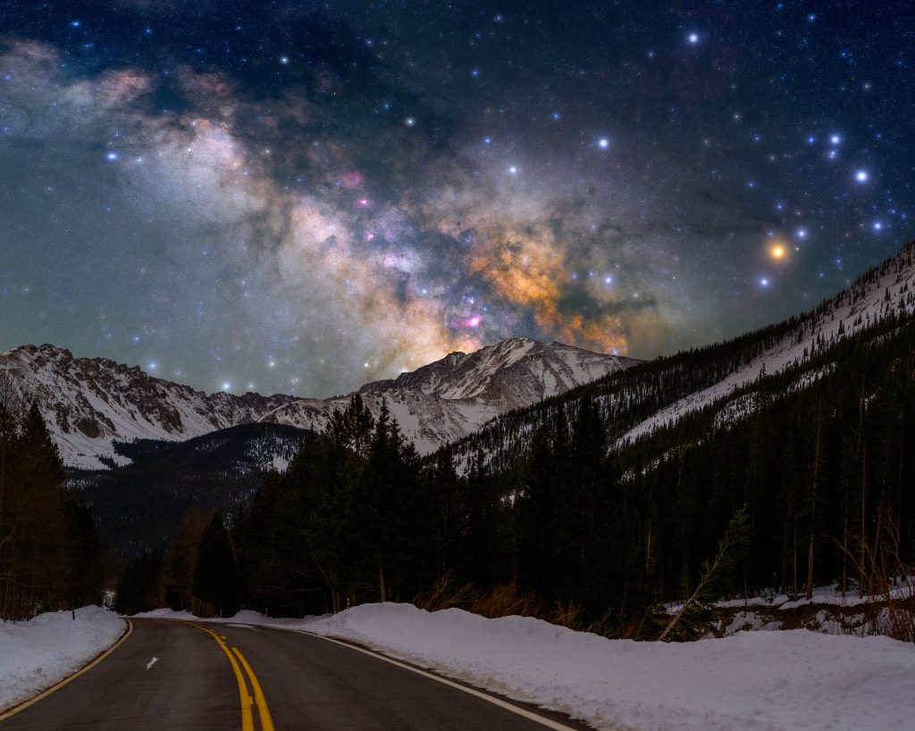 Night sky over Leadville Colorado with stars and historic mining structures silhouetted
